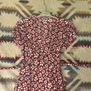 This is A Red Maxi Dress with a bow tie around the waist.